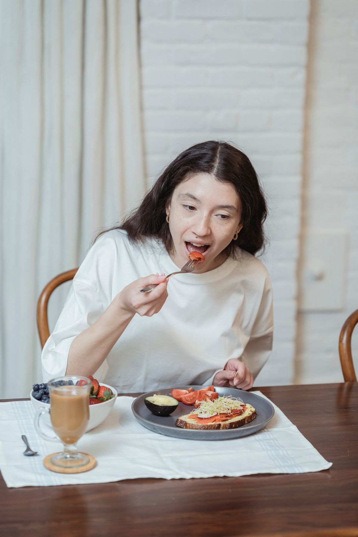 A woman eating a nutritious breakfast with fruit