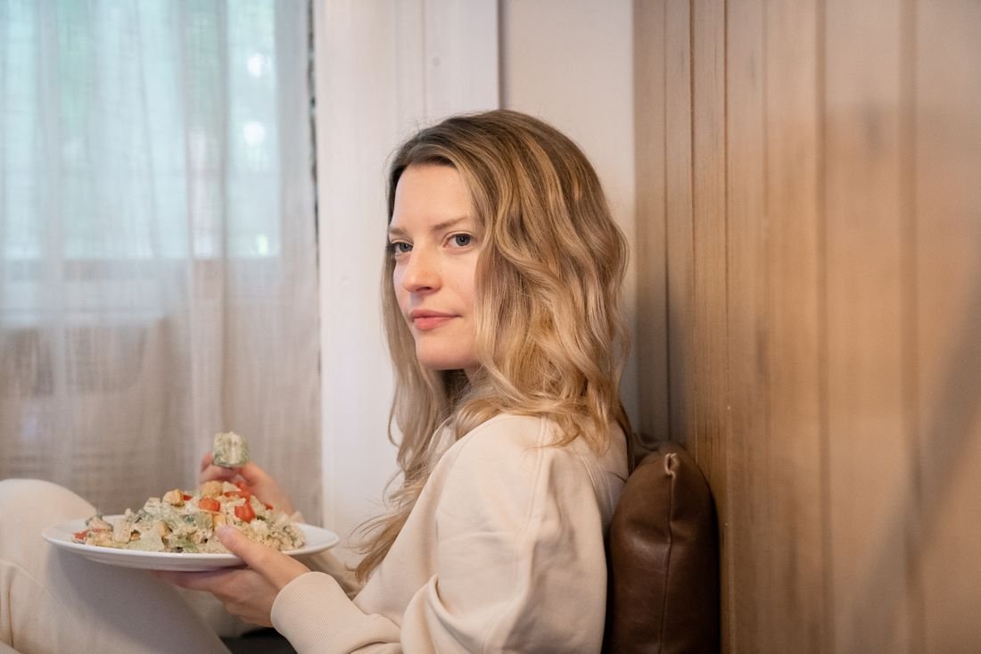 A woman enjoying a meal at home